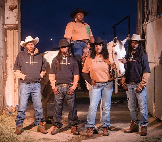 Oklahoma Cowboys Black Pioneers group posing with horse at the rodeo wearing Timberland boots