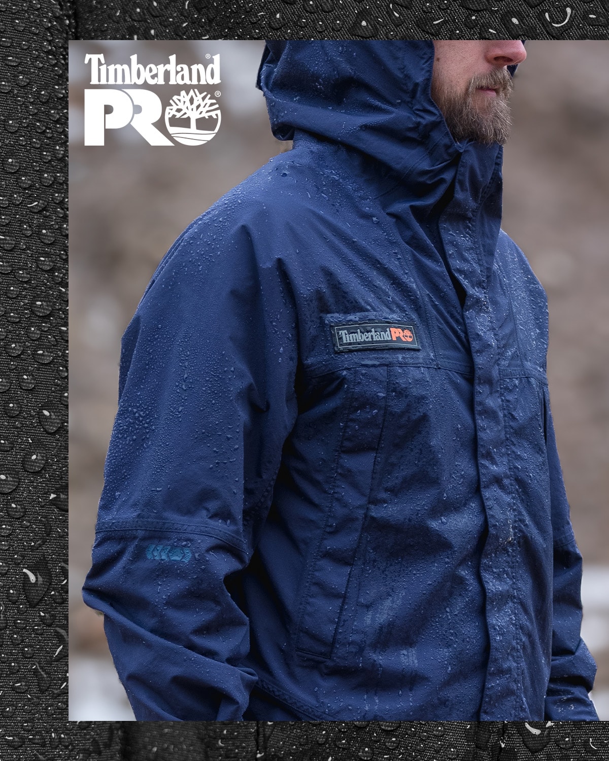 image of a man wearing a navy blue Timberland PRO water resistant jacket with the hood up